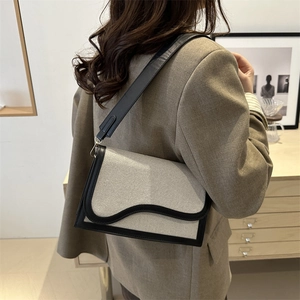 Modern color-block shoulder bag with canvas and black leather splicing details