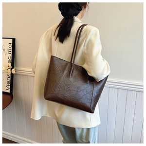 Detail view of the deep brown vintage tote bag with unique wrinkled leather texture