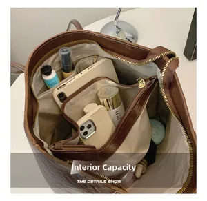 Interior view of the brown leather tote bag showing organized multi-pocket storage