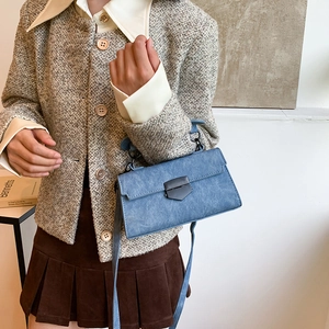 Retro blue stone pattern crossbody bag with metal buckle shown in a lifestyle setting