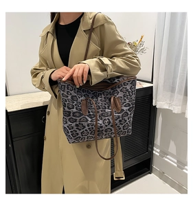 Close-up of leopard print tote bag with brown leather handles and large capacity