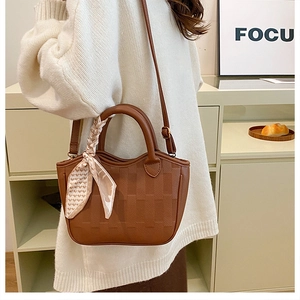 Brown lychee grain leather bucket bag with silk scarf handle and long shoulder strap