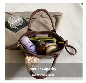 Macro view of brown leather bucket bag interior showcasing large storage capacity