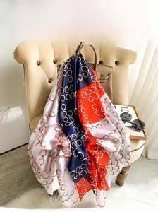 Detail of vintage chain print satin scarf with bright orange and navy color block