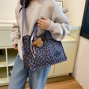 Leopard print canvas tote bag with purple straps and cute brown bear pendant accessory