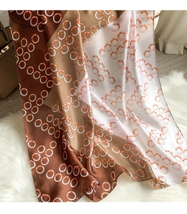 Detailed texture of silk scarf with geometric circles on soft plush background