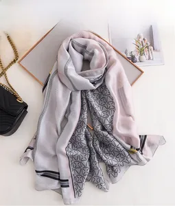 Detail of elegant pink and grey geometric silk scarf with chain pattern and contrast edges