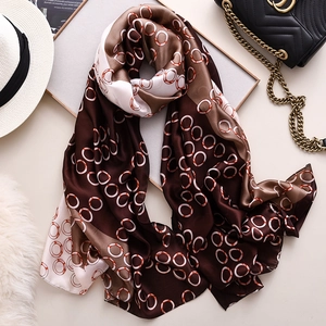 Brown silk-like scarf with geometric rings and fashionable accessory arrangement