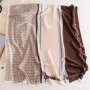 Detail of elegant faux silk scarf with equestrian chain patterns and heritage stripe design