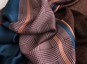 Detail of silk scarf with houndstooth and geometric patterns showing fabric texture