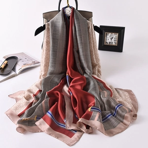 Elegant silk-like scarf with wine red blocks and houndstooth pattern on a hanger