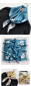 Détail d'un foulard en soie avec motif de fleurs blanches sur fond bleu et jaune