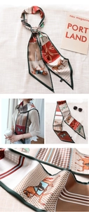 Macro detail of silk-like twilly scarf with retro horse harness and stirrup print