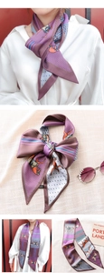 Detail of printed polyester skinny scarf featuring horse patterns and geometric borders