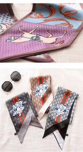 Detail view of equestrian pattern and cartoon prints on narrow silk-feel scarves