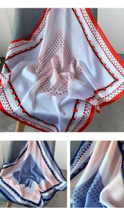 Détail de l'écharpe en soie avec motifs géométriques élégants et finition brillante