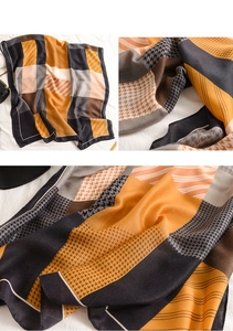 Détail d'un foulard en satin avec pied-de-poule orange et rayures géométriques