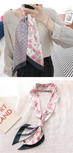 Close-up of a long silk scarf with orchid print, G-pattern, and dark green borders
