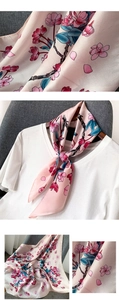 Gros plan sur l'imprimé fleur de cerisier rose d'une écharpe en satin de soie douce