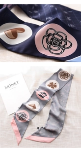 Detail of a narrow satin scarf with camellia motifs and multi-color patchwork design