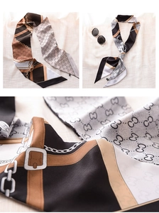 Detail of luxury silk twilly scarf with interlocking G patterns and chain designs