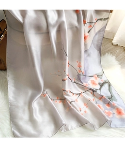 Detailed texture of silver silk scarf featuring elegant plum blossom ink painting