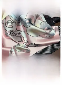 Close-up of printed silk scarf featuring fine double-stitched edges and smooth fabric texture