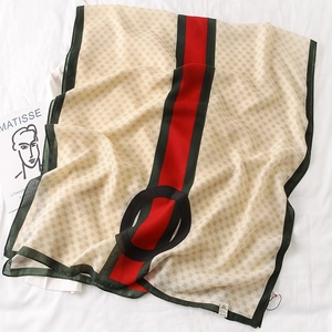 Detail of silk-feel square scarf with monogram print and green striped border
