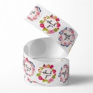 Macro detail of round floral thank you stickers roll with colorful vintage rose patterns