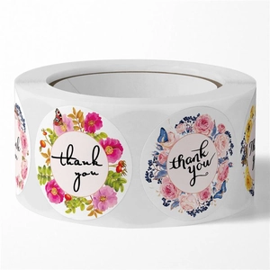 Detailed view of floral self-adhesive thank you stickers in a roll for wedding decor