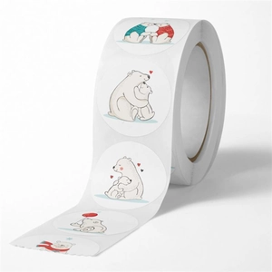 Macro view of round cartoon polar bear stickers on a roll for gift wrapping and rewards