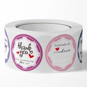 Macro view of floral thank you sticker roll with heart motifs and writing space