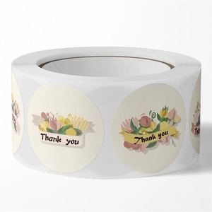 Close-up of floral Thank You stickers roll for wedding gift wrap and envelope sealing