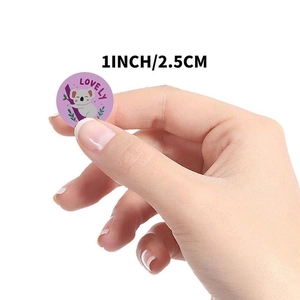 Close-up of 1 inch round purple sticker featuring a cartoon koala and Lovely text