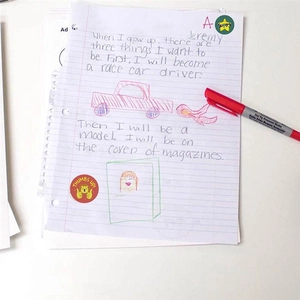 Cartoon reward stickers for kids and dual-tip marker on student homework sheet