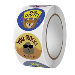 Macro shot of colorful round reward sticker roll with cute cartoon fox and stone patterns