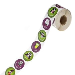 Roll of cartoon owl Halloween stickers with purple and green festive designs for decorations