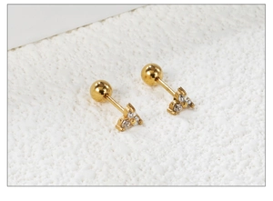 Close-up of gold stainless steel triangle stud earrings with white zircon crystals
