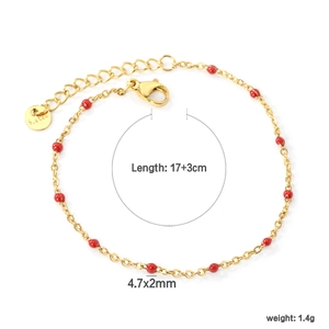 Detail of red beads on a minimalist gold stainless steel chain with adjustable lobster clasp