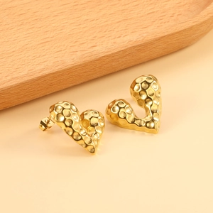 Hammered gold heart stud earrings with unique metal texture in minimalist hip-hop style