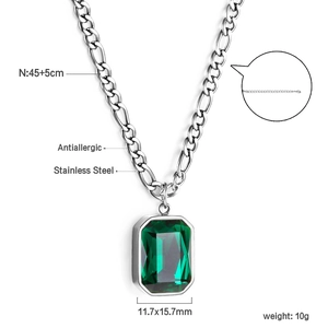 Close-up of emerald-cut green gemstone necklace with Figaro chain and size specs