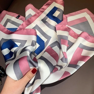 Detail of silk-like scarf featuring modern geometric stripes and smooth texture