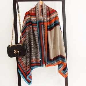 Detail of colorful paisley cotton-linen blend large square scarf with geometric print