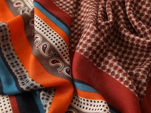 Detailed macro shot of vintage bohemian shawl fabric with ethnic paisley patterns