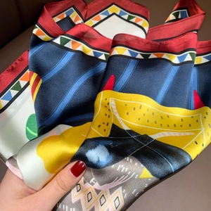 Close-up of silk scarf showing artistic geometric patterns and premium soft texture