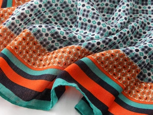 Close-up of geometric patterned cotton-linen scarf with elegant blue and orange textures