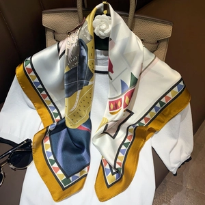 Luxurious printed silk scarf with geometric patterns paired with elegant accessories