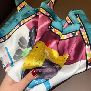 Detailed view of colorful printed silk scarf featuring abstract geometric patterns and texture