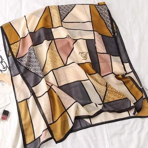 Detailed macro view of geometric patchwork pattern and texture on soft cotton linen scarf