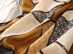 Close-up of geometric chain print scarf showing soft cotton-linen texture and earthy tones